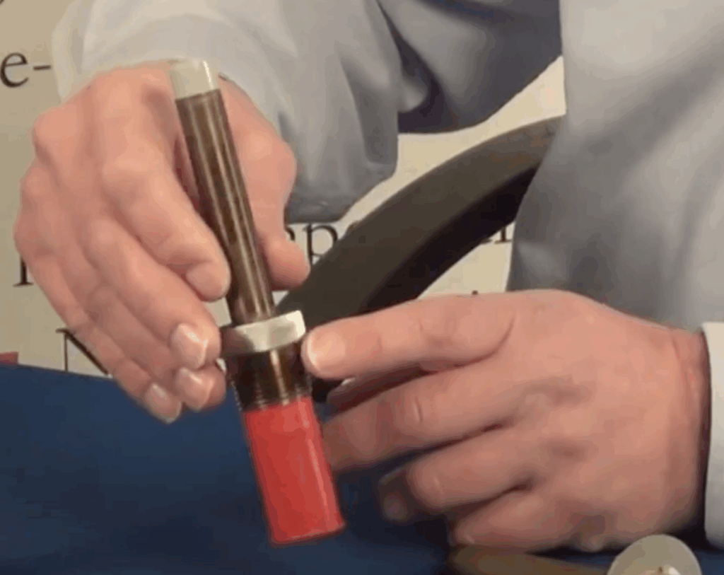 Close-up of a technician holding a Wing Corp. heat detector unit during demonstration.
